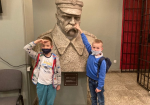 Uczniowie przed popiersiem marszałka Józefa Piłsudskiego.
