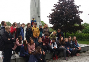Park Helenów. Grupa uczniów stoi przed pomnikiem Armii Łódź